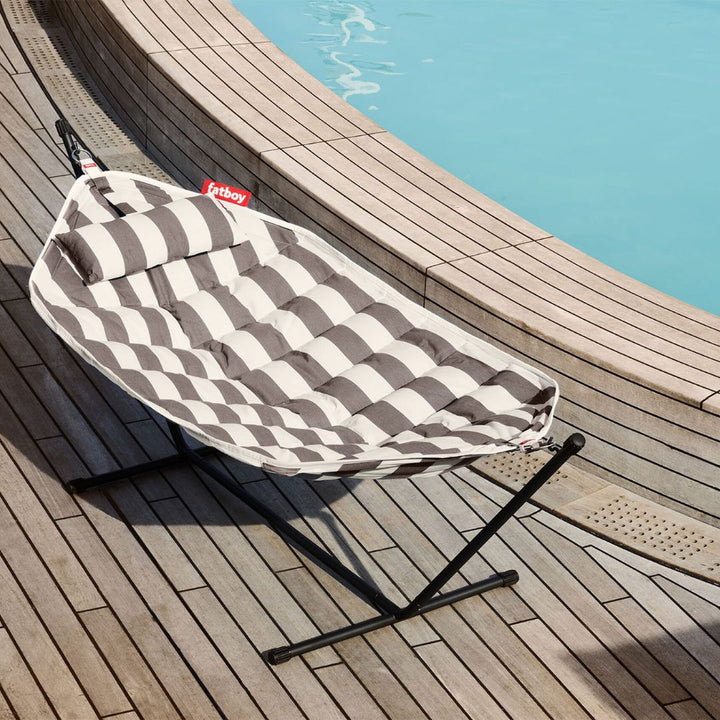 Stripe cacao and white hammock with quilted fabric and matching pillow, suspended on a sturdy black powder-coated metal frame, by Fatboy, from Desert River Shop.